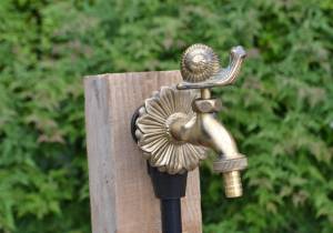 Snail ornamental garden tap brass colour