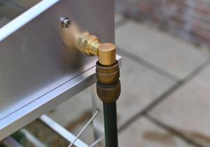 Hose connected to growhouse watering system