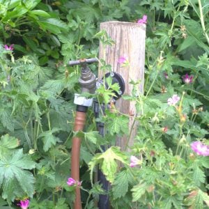 outside tap on a post in the garden